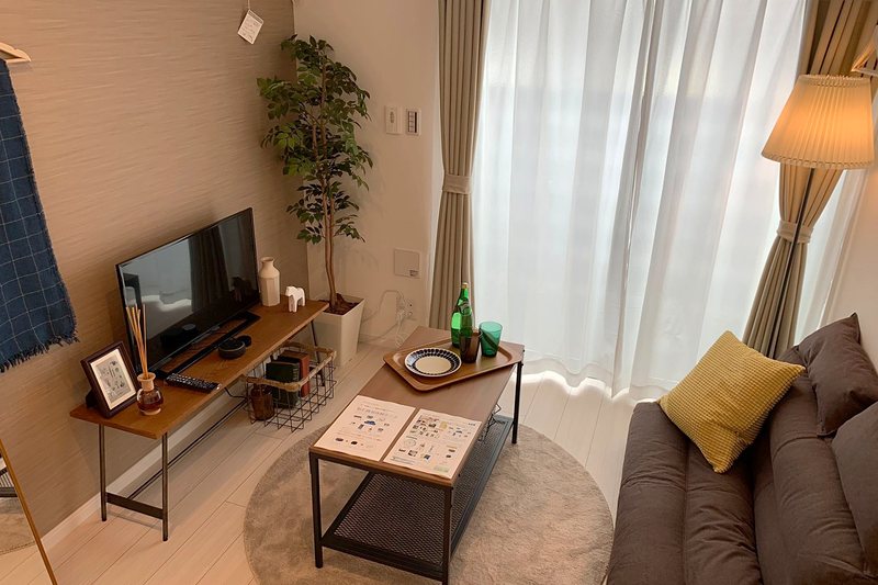 アトランティス東大宮のモデルルーム。テレビとソファ、ローテーブルの居室